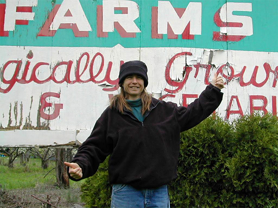 Vintage shot of Amy in front of farmstand sign